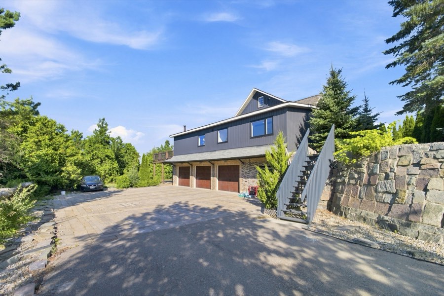 Detached three-bay garage with a loft above and an exterior stair to the upper level