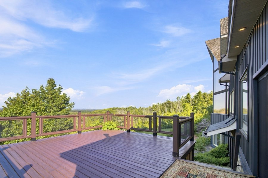 Upper deck with timber railings looking out over treetops and rolling countryside