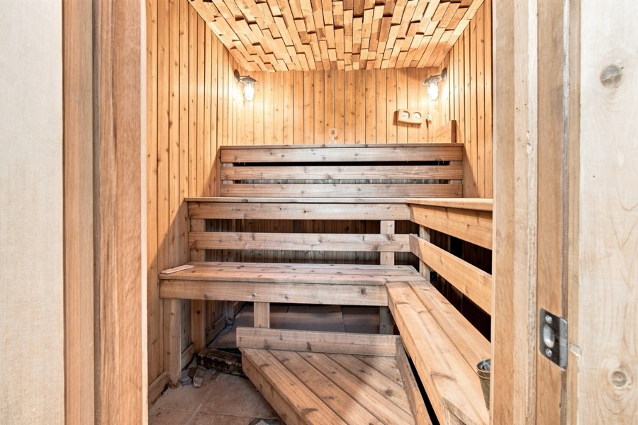 Cedar sauna with tiered benches and a slatted ceiling